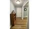 Hallway featuring durable wood-look floors, neutral paint, with a white door and trim, offering timeless style at 3975 N Sharon Church N Rd, Loganville, GA 30052