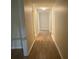 Hallway featuring hard surface flooring and neutral paint, leading to multiple rooms at 3975 N Sharon Church N Rd, Loganville, GA 30052