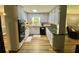 Well-lit kitchen with stainless steel appliances, white cabinetry, and granite countertops at 3975 N Sharon Church N Rd, Loganville, GA 30052