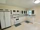 Bright kitchen with white cabinets, appliances, countertops and a window for natural light at 3975 N Sharon Church N Rd, Loganville, GA 30052