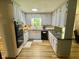 Well-lit kitchen with stainless steel appliances, white cabinetry, and granite countertops at 3975 N Sharon Church N Rd, Loganville, GA 30052