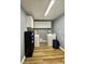Well-organized laundry room with washer, dryer, and storage shelves at 3975 N Sharon Church N Rd, Loganville, GA 30052