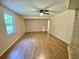 Spacious living room with ample natural light from large window, fan and doorway to hallway at 3975 N Sharon Church N Rd, Loganville, GA 30052