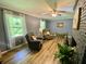 Spacious living room with great natural lighting, fan and comfortable seating arrangement at 3975 N Sharon Church N Rd, Loganville, GA 30052