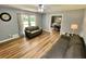 Serene living room with natural light, hardwood floors and an open doorway to the dining room at 3975 N Sharon Church N Rd, Loganville, GA 30052