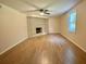 Bright living room features a brick fireplace, window and newer flooring at 3975 N Sharon Church N Rd, Loganville, GA 30052