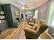 Cozy living room with fireplace, ceiling fan, and comfortable seating arrangement at 3975 N Sharon Church N Rd, Loganville, GA 30052