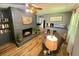 Inviting living room with fireplace, wood floors, and built-in bookshelves at 3975 N Sharon Church N Rd, Loganville, GA 30052