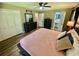 Bright main bedroom featuring wood floors, neutral paint, and access to an ensuite bathroom at 3975 N Sharon Church N Rd, Loganville, GA 30052