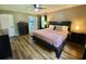 Comfortable main bedroom with wood floors and a view into the attached ensuite bathroom at 3975 N Sharon Church N Rd, Loganville, GA 30052