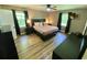 This is a beautiful main bedroom featuring a large bed, side tables, and wood floors at 3975 N Sharon Church N Rd, Loganville, GA 30052