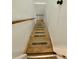 Wooden stairs descending towards the lower level of the home at 3975 N Sharon Church N Rd, Loganville, GA 30052