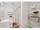 Bright bathroom featuring a glass shower and wire shelving for storage at 526 Summer Ter, Woodstock, GA 30189