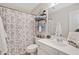 Neutral bathroom with a shower curtain and open shelving for storage at 526 Summer Ter, Woodstock, GA 30189