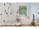 Bright primary bathroom featuring a soaking tub and walk-in shower at 526 Summer Ter, Woodstock, GA 30189