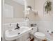 Cozy half bathroom with pedestal sink and decorative wall art at 526 Summer Ter, Woodstock, GA 30189