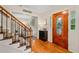 Inviting home foyer with wood door, hardwood floors, and staircase at 526 Summer Ter, Woodstock, GA 30189