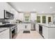 Modern kitchen with stainless steel appliances, white cabinets, and subway tile backsplash at 526 Summer Ter, Woodstock, GA 30189