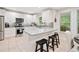 Modern kitchen with stainless steel appliances, white cabinets, and breakfast bar seating at 526 Summer Ter, Woodstock, GA 30189