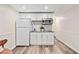 Kitchenette featuring white cabinets, stainless steel microwave, and granite countertops at 526 Summer Ter, Woodstock, GA 30189