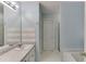 Well-lit bathroom showcasing a tiled backsplash, a white vanity, and a bathtub near a shower at 571 Oak Vista Ct, Lawrenceville, GA 30044