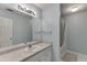 Well-lit bathroom with vanity, mirror, and bathtub with shower at 571 Oak Vista Ct, Lawrenceville, GA 30044