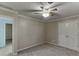 Neutral bedroom showcasing a ceiling fan, closet, and plush carpet at 571 Oak Vista Ct, Lawrenceville, GA 30044