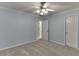 Spacious bedroom with two doors, light blue walls, carpet, and a ceiling fan with light fixture at 571 Oak Vista Ct, Lawrenceville, GA 30044