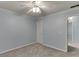A calm bedroom with light blue walls, carpet, a ceiling fan, and two white doors at 571 Oak Vista Ct, Lawrenceville, GA 30044