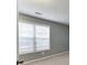 Grey bedroom featuring carpet, window with blinds, and natural light at 571 Oak Vista Ct, Lawrenceville, GA 30044