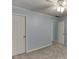 A serene bedroom with two doors, light blue walls, carpet flooring, and a ceiling fan at 571 Oak Vista Ct, Lawrenceville, GA 30044