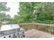 Exterior view of a deck featuring a grill and view of a tree lined backyard at 571 Oak Vista Ct, Lawrenceville, GA 30044