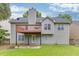 Exterior of home displaying a backyard featuring a concrete patio, and a wood deck at 571 Oak Vista Ct, Lawrenceville, GA 30044