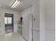 Bright kitchen offers white cabinets, countertops and tile backsplash at 571 Oak Vista Ct, Lawrenceville, GA 30044
