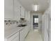 Bright kitchen offers white countertops, cabinetry and tile backsplash at 571 Oak Vista Ct, Lawrenceville, GA 30044