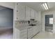 Bright eat-in kitchen offers white cabinets, countertops and tile backsplash at 571 Oak Vista Ct, Lawrenceville, GA 30044