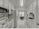 Bright eat-in kitchen features white cabinetry, appliances and tile backsplash at 571 Oak Vista Ct, Lawrenceville, GA 30044