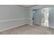 Open living area with carpet flooring and access to kitchen and bedroom at 571 Oak Vista Ct, Lawrenceville, GA 30044