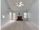 Bright living room with vaulted ceilings, fireplace, and neutral carpet at 571 Oak Vista Ct, Lawrenceville, GA 30044