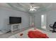 Spacious main bedroom features tray ceiling, tv and ensuite bathroom at 571 Oak Vista Ct, Lawrenceville, GA 30044