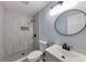 Updated bathroom featuring a modern vanity, new tile shower with a shower niche and matte black finishes at 6906 Shangrila Way, Riverdale, GA 30296