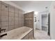 Bathroom features a luxurious soaking tub, tile surround and a separate vanity area at 6906 Shangrila Way, Riverdale, GA 30296