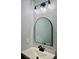 Modern bathroom featuring an arch mirror, modern light fixture, and sleek vanity at 6906 Shangrila Way, Riverdale, GA 30296