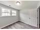 Bedroom with gray walls, wood flooring, two windows and a closet at 6906 Shangrila Way, Riverdale, GA 30296
