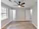 Airy bedroom with a ceiling fan, natural light, and neutral walls at 6906 Shangrila Way, Riverdale, GA 30296