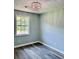 Well-lit bedroom featuring new floors, a modern light fixture, fresh paint, and a bright and airy feel at 6906 Shangrila Way, Riverdale, GA 30296