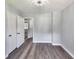 Bedroom with gray walls, wood flooring, 2 closets and an open doorway to another room at 6906 Shangrila Way, Riverdale, GA 30296