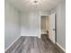 Bedroom with gray walls, wood flooring, and an open doorway to another room at 6906 Shangrila Way, Riverdale, GA 30296