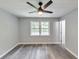 Inviting bedroom features a ceiling fan, two windows, and neutral paint at 6906 Shangrila Way, Riverdale, GA 30296