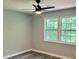 Bright bedroom with fresh paint, new flooring, a modern ceiling fan, and two large windows providing ample natural light at 6906 Shangrila Way, Riverdale, GA 30296
